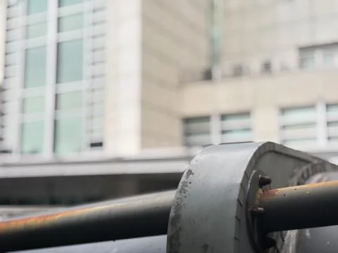 Focusing on an industrial pipe connection element in the foreground Stock Photos