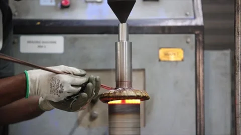 Focusing on the intense brazing point where technician applies a copper filler Stock Footage 327803858