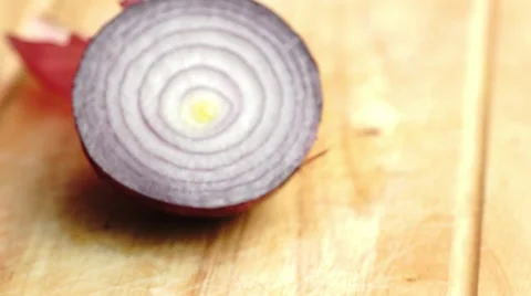 Focusing in on a juicy half cut raw purple onion Stock Footage 68780371