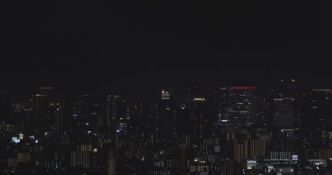 Focusing on landing airplanes Night view of Osaka Building street Stock Footage 153307749