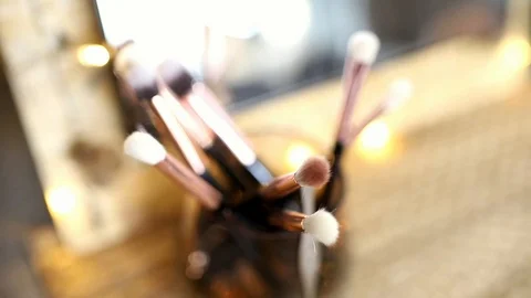 Focusing on makeup brushes in a container Stock Footage 121040836