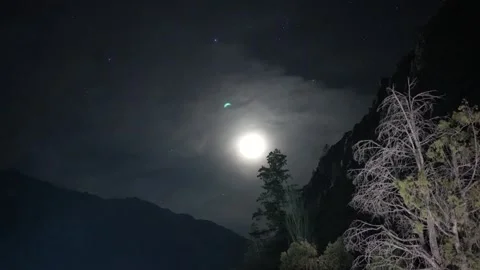Focusing on the moon shining in the sky amidst the mountains in Himachal, India. Stock Footage 273765417