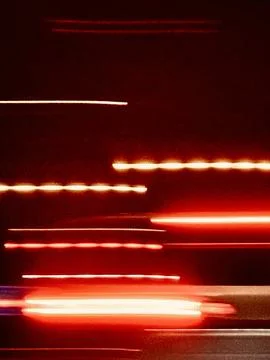 Focusing on neon light trails, long shadows under streetlights Stock Photos