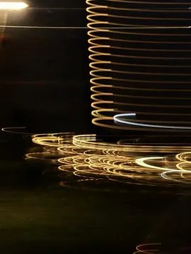Focusing on neon light trails, long shadows under streetlights Stock Photos