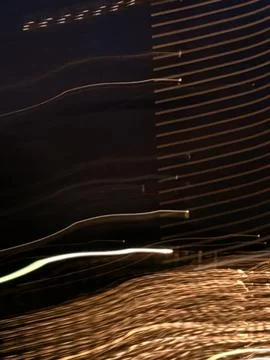 Focusing on neon light trails, long shadows under streetlights Stock Photos