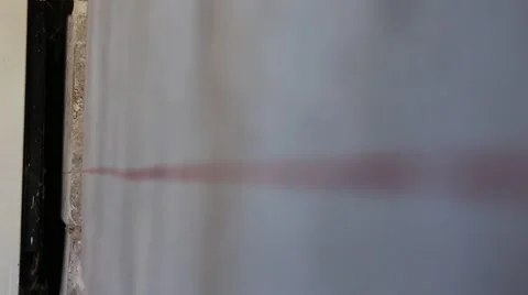 Focusing red line on the grey wall. Abstract. Stock Footage 44271163