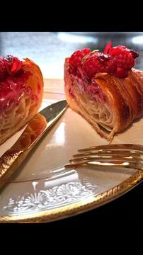 Focusing on simple yet sophisticated presentation of croissant with raspberries Stock Photos