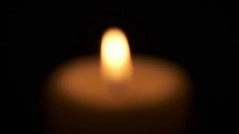 Focusing on Single Candle Flame Burning in Dark Stock Footage 125462148