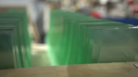 Focusing through a pile of clear glass panels on the shelf. Stack of glass Stock Footage 124060168