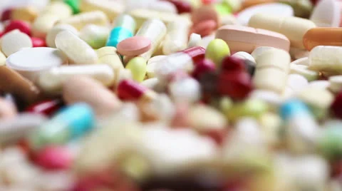 Focusing on turning medicine pills Stock Footage 24480088