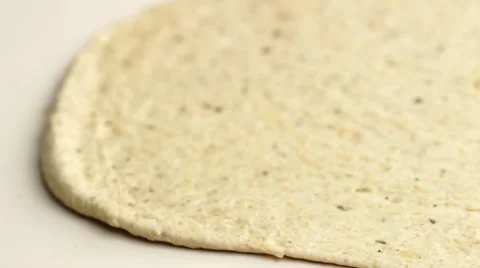 Focusing in on uncooked rolled pizza pastry dough, macro shallow depth of fie Stock Footage 68752828