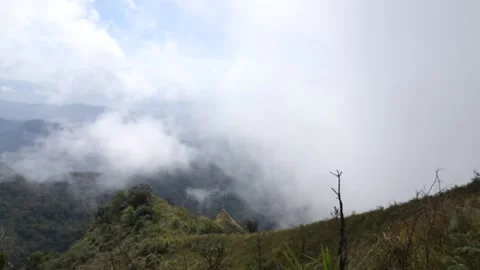 Fog above the mountain top time lapse Stock Footage 154838760