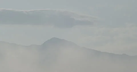 Fog and clouds above and around Parangul mare 4K slomo video Stock Footage 252858945