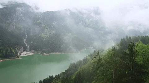 Fog and clouds on alpine lake Lago di Cadore in Dolomites mountains, Cortina Stock Footage 265097868