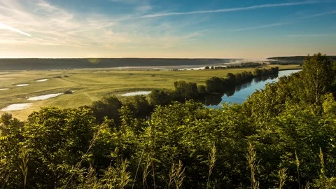 Fog and clouds dissipate disappear over the river, field and forest 動画素材 77267330