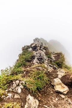 Fog and clouds enveloping the steep ridge of the majestic Schaefler peak in t Foto stock