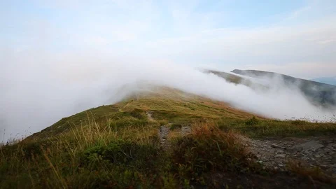 Fog and clouds over mountains ridge landscape. Timelapse footage. Stormy weat Stock Footage 121198667