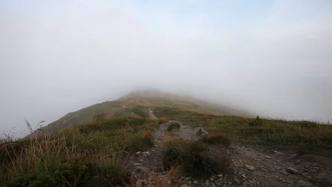 Fog and clouds over mountains ridge landscape. Timelapse footage. Stormy weat Stock Footage 121198725