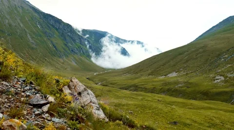 Fog and clouds rolling over the mountain yellow hills 스톡 동영상 65764084