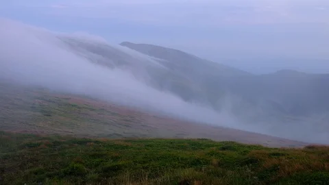 Fog and clouds under mountains ridge landscape timelapse. Stormy weather at h Stock Footage 120792816