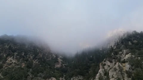 Fog and Low Clouds over a Mountain Range Seen from an Aerial View Stock Footage 264008791