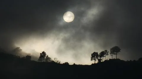 Fog and rain clouds hide the fall end sun on Barbeito hill. 4k P10150530 Stock Photos
