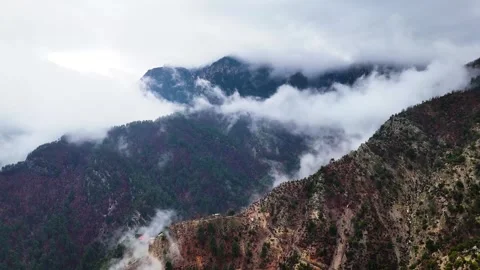 Fog Backflow Across Dramatic Mountain Ridges Reverse 4K Stock Footage 331265800