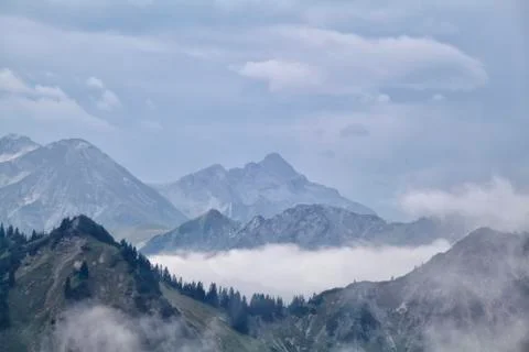 Fog between mountain ridges Stock Photos