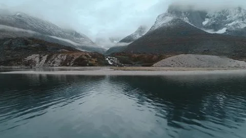 Fog between two mountain spiers by the lake Stock Photos