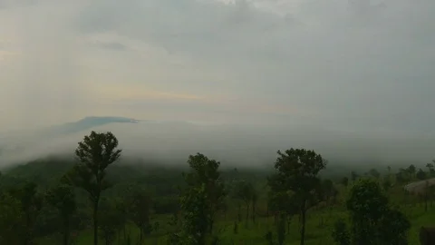 Fog blowing over the hill in sunset time Stock Footage 82830243