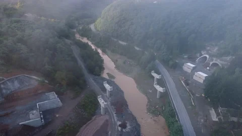 Fog on the bridge and tunnel construction in the mountains Stock Footage 168570884