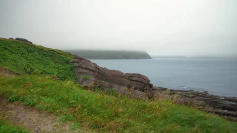 Fog clings to the desolate headland of Cape Spear, Newfoundland Stock Footage 284679687