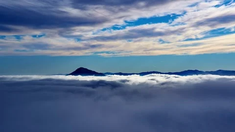 Fog clouds moving in alpine nature in morning light. Timelapse Video stock 295225059