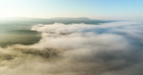 Fog covered valley at sunrise Stock Footage 334252805