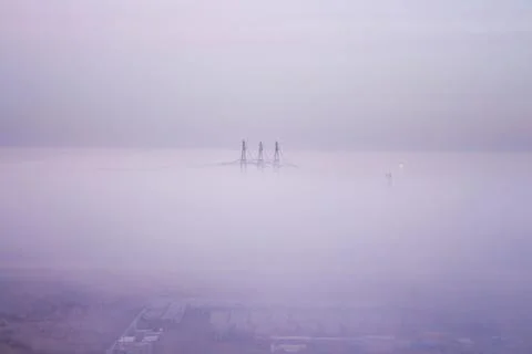 Fog covers electrotowers Stock Photos
