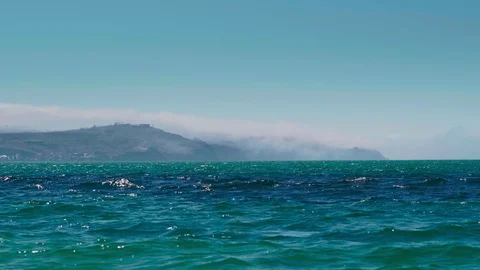 The fog covers the mountain far away from the sea Stock Footage 126787735