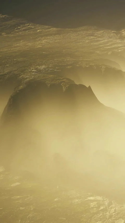 Fog covers rocky terrain under dim light during early morning hours Stock Footage 334260200