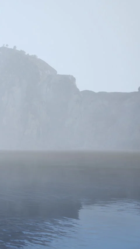 Fog covers water and mountain at dawn near lake Stock Footage 339399500