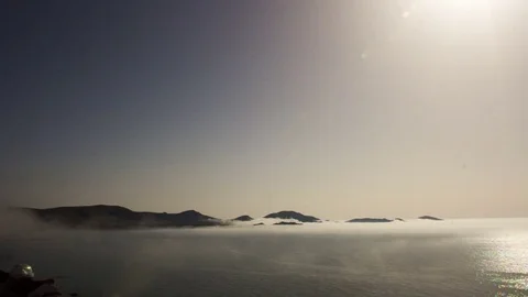 The fog crawls from the sea to the mountains Stock Footage 79434440