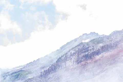 Fog create layers of mountain view in soft purples and blues Stock Photos