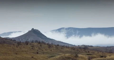 Fog creeps over mountain valley Stock Footage 73032297