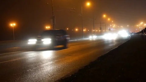 In the fog is difficult to see the busy traffic of cars on the night road 4K Stock Footage 82979180