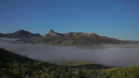 Fog donkey in the valley against the backdrop of the mountain Stock Footage 76425286