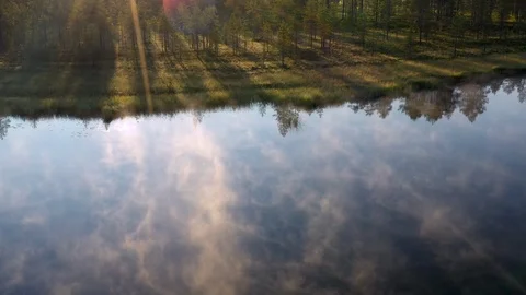 Fog drifting over mirror calm pond of a boreal forest in Finland Stock Footage 124402236