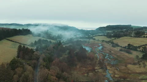 Fog drifting over a river valley in the Irish countryside aerial Video stock 154810163