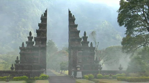 The fog drifts by a traditional Balinese temple gate in Stock Footage