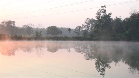 The fog evaporates above the water surface in the morning Stock Footage 118709256