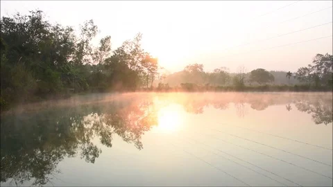 The fog evaporates above the water surface in the morning Stock Footage 118709330