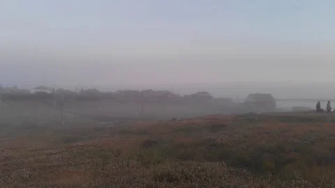 Fog in the evening in the village Stockbeeldmateriaal 100998805