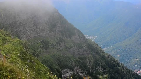 Fog falling down from the mountains in summer Stock Footage 242950900